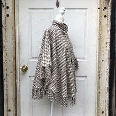 This Beautiful Hand Embroidered pullover poncho is perfect for keeping you stylish during those breezy sunny days. It has gorgeous hand embroidered details from top to bottom. Same design back and front. MADE IN MEXICO By: Mexican Artisans For: Women Size: One Size Color: off-white | gray Measurements: Neck to end: 24" Shoulder to shoulder: 40.5" All ponchos are measured lying flat, not stretched but relaxed. All measurements are inches Details: 100% cotton Pullover poncho Toggle closure Tassels Winter Embroidered Long Sleeve Poncho, Oversized Embroidered Bohemian Tops, Bohemian Embroidered Oversized Tops, Oversized Fringe Casual Poncho, Bohemian Oversized Embroidered Tops, Oversized Fringe Poncho Casual Style, Embroidered Tunic Tops For Fall, Fall Vacation Cotton Tunic, Bohemian Long Sleeve Embroidered Poncho