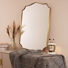 a mirror sitting on top of a dresser next to a table