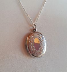 Vintage Victorian revival signed sterling silver 925 oval locket pendant necklace with beautiful floral hand engraving - can open to keep 2 photos. pendant: 1-1/8 x 7/8 x 1/8 inches. Weight: 7.2 gr. Chain : 18 inches. Good vintage condition with very fine surface scratches mostly on the back side and mostly visible under a loop - sold as is. Signed R and marked 925 in the interior of the locket and marked 925 on the chain.   IMPORTANT TO READ: To make this a smooth and pleasant transaction experience for everyone, all buyers need to read and understand the description, the terms of sale , the payment and the shipping indicated in this listing. TERMS OF SALE A. SHIPPING WORLDWIDE This listing includes payable tracked services with the fees indicated below.  B. CARRIERS We don't ship with Fe Antique Silver Locket Necklace With Oval Pendant, Antique Silver Oval Pendant Locket Necklace, Antique Silver Oval Pendant Necklace With Locket, Antique Silver Necklace With Oval Locket Pendant, Antique Sterling Silver Etched Locket Necklace, Antique Etched Sterling Silver Locket Necklace, Vintage Silver Oval Pendant Locket Necklace, Antique Medallion Necklace Stamped 925, Antique Sterling Silver Locket Necklace Hallmarked