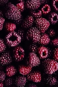 raspberries are shown next to a bottle of liquid