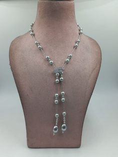 This Exclusively Elegant Pearl Lariat Necklace is the perfect statement piece for any occasion. Crafted from freshwater pearls and finished with an elegant silver clasp, this necklace adds a touch of sophistication to any wardrobe. The stunning design and high quality materials guarantee this necklace will make heads turn. The Length of the necklace is 30" What is a lariat style necklace:-The lariat necklace is a lengthy and sleek necklace style that typically features a dangling ornament such a Lariat Style Necklace, Pearl Lariat Necklace, Pearl Lariat, Kundan Necklaces, Elegant Necklace, Cz Jewelry, American Diamond, Elegant Necklaces, I Love Jewelry