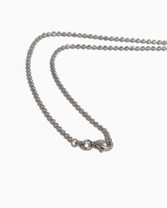 The Glimmer Bead Chain, handcrafted in sterling silver, features a distinctive link structure that subtly shimmers when kissed by the light. Ideal for showcasing a pendant or as a standalone piece, this chain effortlessly complements any look. Metal: Sterling silver Chain Width: 2mm Chain Length: 18" Style #: GLIM White Gold Charm Necklaces With Adjustable Chain, Everyday White Gold Pendant Chain Necklace, Everyday Metal Necklaces With Rolo Chain, White Gold Pendant Charm Necklace With Lobster Clasp, Classic Jewelry With Rolo Chain Link, Silver Stainless Steel Heart Pendant Chain Necklace, Silver Stainless Steel Heart Pendant Necklace, Dainty White Gold Chain Necklace With Round Pendant, Minimalist Stainless Steel Oval Link Jewelry