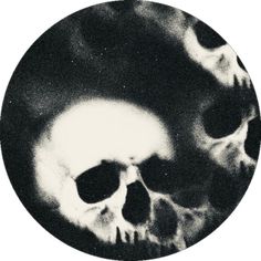 a black and white photo of two skulls in a circle with their faces slightly open