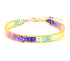 a multicolored beaded bracelet on a gold plated metal hook clasp chain