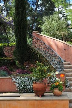 an outdoor area with stairs and potted plants