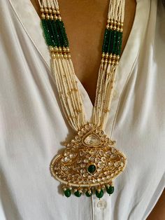 All our pieces are in stock and will be dispatched within 24 to 48 hours of order. Orders received during the weekend will be dispatched on Monday. The white and green beads strings on both sides of an elegant Kundan pendant make it a statement wedding necklace. One of our favorite picks for the wedding season ❤️ Dimensions Weight of the necklace: 78 grams Drop Length of the necklace: 12 inches Height of pendant: 3.5 inches Width of pendant: 3 inches Weight of earrings is 46 g per pair. Length o Ornate Pendant Jewelry For Wedding, Chandbali Jewelry With Jewels As Gift, Handmade Chandbali Jewelry For Wedding, Handmade Chandbali Wedding Jewelry, Unique Festive Jewelry With Large Pendant, Unique Large Pendant Jewelry For Festive Occasions, Gold Chandbali Beaded Necklaces For Wedding, Ornate Kundan Pendant Necklace For Wedding, Gold Chandbali Beaded Necklace For Wedding