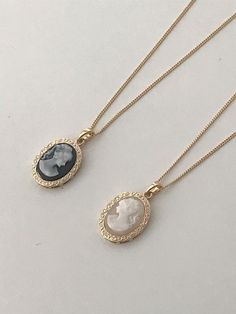 This elegant long necklace features a signature European cameo lady pendant motif, available in both cream and black colorways with premium brass and 14k gold electroplating. The versatile 60cm chain with 5cm extension perfectly complements the moderately sized 2cm pendant, striking an ideal balance between statement and subtlety. The vintage-inspired design effortlessly elevates any outfit while maintaining a timeless, antique-mood aesthetic that makes it a sophisticated addition to any jewelry collection.Color: Cream Cameo, Black Cameo Vintage Statement Necklace, Old Money Accessories, Vintage Opulence, Black Cameo, Mood Aesthetic, Vintage European, Old Money Style, European Vintage, Timeless Jewelry