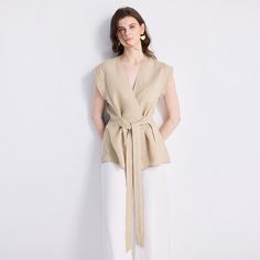 Our Power Moves Top is a wardrobe must-have, your ultimate summer staple! This beautiful wrap top in neutral beige works as well for the office as it does for a dinner with friends. Pair it with sleek trousers or a pair of jeans and see where your day takes you. Versatile Beige V-neck Blouse, Beige V-neck Blouse For Office, Versatile Summer Wrap Top, V-neck Wrap Top With Tie Waist For Work, Chic Summer Wrap Top, Versatile Summer V-neck Wrap Top, Chic Taupe V-neck Top, Summer Khaki V-neck Blouse, Beige V-neck Top For Work