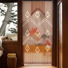 a room with a sliding glass door that has beaded designs on it