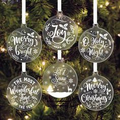 four ornaments hanging from a christmas tree with the words joy and merry written on them