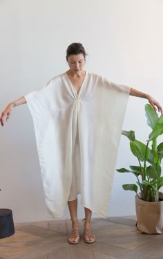 A favorite signature piece.. Our Luxurious silk caftan, with a very soft hand. Handwoven silk. deep v caftan. As worn by Angelina Jolie in Vogue. Our signature silk caftan feels great on and is perfect even for a beach wedding! Slightly sheer. The silk fabric is handwoven and may have hand made inconsistencies which are part of its look. Color: Natural white — Length 48" Width 45" — handwoven silk fabric — One size White Kaftan Dress, White Kaftan, Silk Caftan, Simple Fabric, Kaftan Designs, Summer Beach Dress, Wardrobe Planning, Sari Fabric, Silk Sari