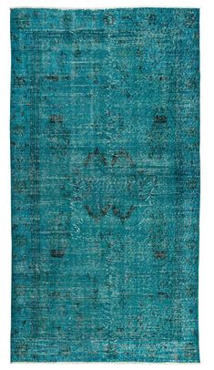 an antique rug with blue and green colors