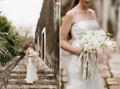 a woman in a white dress holding a bouquet and standing next to an alleyway