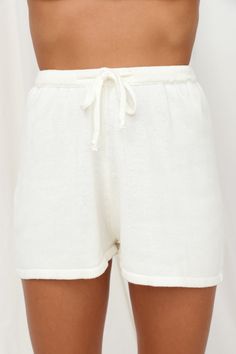 Length from waist to hem of size S: 38cm. 
 White shorts. 
 Non-lined. 
 Cold hand wash only. 
 Model is a standard XS and is wearing S. 
 True to size. 
 Soft and stretchy cotton-blend fabric. 
 Slip-on style. 
 Elasticated waist. 
 Cotton/Acrylic. 
 Keep comfy in the Flight Mode Shorts! These loose shorts are made from the softest material and have an elastic waistband for adjustable comfort all day long! Yemen Clothing, Flight Mode, Short Blanc, Children Shoes, Shorts White, Loose Shorts, Dress Romper, White Shorts, Designer Dresses