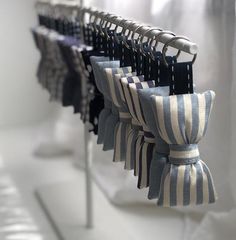 several black and white striped ties hanging on a rack