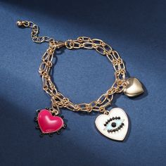 Feel the love with our Evil Eye Heart Bracelet. Crafted with a singular focus, this bracelet offers an exquisitely-crafted representation of protection and love, alluringly adorned with a delightful heart bearing an eye at its center. Ensuring that the wearer is blessed by the all-seeing eye of affection, this luxurious piece is sure to captivate and enchant. Detail Plating: 18K Gold Materials: 18K Gold on Alloy Size:  Length:6.69 "(17cm)+Extender: 2.17"(5.5cm ) Weight: 17.9g Astrology Jewelry, Cat Pendant Necklace, 18k Gold Bracelet, Unique Gift Wrapping, All Seeing Eye, Horses Pendant, Gold Charm Bracelet, Cat Pendants, Globe Pendant