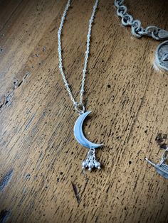 "Love this Sterling Silver Crescent Moon with it's bead bundle (stars anyone?) at about 1\" in length! A gorgeous combination of 2D and 3D and a little movement come together in this sweet design. It makes beautiful necklace on a 16\" or 18\" sterling beaded chain. A simple celestial gift or for yourself. These are pretty alone or stacked with other necklaces. Comes wrapped in a recycled-paper and velvet-ribboned gift box, per your request with no extra charge! - See options to the right. FREE d Adjustable Sterling Silver Charm Necklace With Moon Charm, Bohemian Sterling Silver Moon Charm Necklace, Bohemian Sterling Silver Necklace With Moon Charm, Spiritual Moon Charm Jewelry For Wedding, Spiritual Moon Charm Jewelry For Mother's Day, Bohemian Sterling Silver Jewelry For Mother's Day, Sterling Silver Moon Charm Necklace For Wedding, Sterling Silver Moon Charm Jewelry Gift For Her, Sterling Silver Moon Charm For Jewelry Making