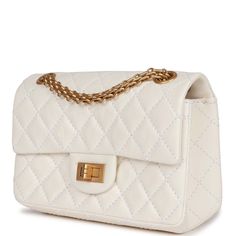 This Mini Reissue 224 2.55 Single Flap bag is in White aged calfskin with antique gold hardware, front flap with a mademoiselle turnlock closure, half moon back pocket, and interwoven gold tone chain link.The interior is lined in white leather with one zip pocket and one slip pocket on the back wall.Collection: 22A (RFID)Origin: ItalyCondition: New and never wornAccompanied by: Chanel Box, dustbag, carebook, felt, ribbon, retail UPCMeasurements: 5" width x 7.8" height x 2.75" depth; 11" strap dr White Bags With Cc Turnlock Closure For Evening, White Evening Bag With Cc Turnlock Closure, Classic White Bag With Cc Turnlock Closure, White Leather Shoulder Bag With Cc Turnlock Closure, Classic White Double Flap Bag, White Evening Bag With Double Flap, White Double Flap Evening Bag, White Shoulder Bag With Cc Turnlock For Everyday Use, White Double Flap Formal Bags