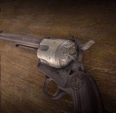 an old revolver with ornate engraved details on the barrel