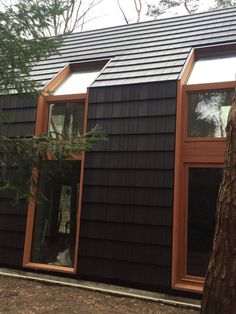 a black house with wood trim and windows