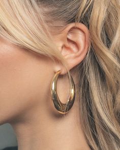 Turn heads no matter where you are! These sleek open hoop earrings are sure to add shine to all of your favorite looks. Available in gold and silver tones. Materials: 14K gold or rhodium plated brass Features: 2.1" hoop, 0.2-0.5" thickness, Lead & Nickel free, post back 60s Hoop Earrings, Gold Hoop Earrings Chunky, Large Hoop Earrings Aesthetic, Hold Hoops Earrings, Chunky Gold Jewelry Earrings, Gold Jewelry Hoops, Gold Earrings Chunky, Thick Gold Earrings, Hoco Jewelry Gold