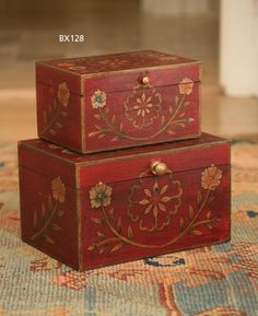 two wooden boxes sitting on top of a rug