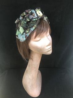 1940s floral print turban style head band. A real statement piece with a standard width inner Alice band attached within the lining to provide an easy to wear design. Completed with quills of fabric, buttons and lined with a fine fleece. The perfect accessory for style and added warmth. This unique creation is a stunning example of a vintage inspired accessory with an eye catching easy to wear and lightweight design. Bohemian Headwrap Headband For Party, Vintage Adjustable Fascinator Headband, Bohemian Party Headband Headwrap, Vintage Spring Headband Headpiece, Bohemian Fitted Headscarf Headband, Fitted Bohemian Headwrap For Spring, Spring Bohemian Fitted Headwrap, Bohemian Green Headwrap As Headband, Bohemian Green Headwrap Style Headband