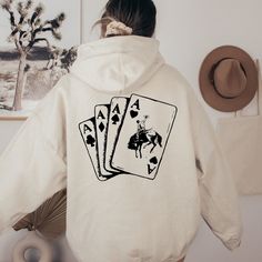 "Ace Card Cowboy Hoodie, Playing Card Sweatshirt, Country Girl Hoodie, Western Sweatshirt, Poker Card Games Hoodie Thank you so much for taking the time to browse my shop. Please feel free to reach out if you have any questions before or after purchasing.   🎨Warning: On products with a print chart in the listing, metallic print colors are printed as matte.✌✨ We design and cut each graphic out with a soft touch, use matte vinyl and a heat press. The result will last for many washes. PRODUCT DESC Western Hoodies, Cowboys Hoodie, Western Sweatshirts, Country Hoodie, Ace Card, Girl Hoodie, Poker Card, Western Apparel, Gaming Hoodie