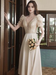 a woman in a white dress standing next to a door