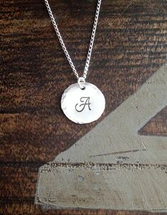 "Sterling Silver Initial Necklace Initial Charm Necklace Initial Necklace Monogram Necklace Bridesmaid Gift Gift for Mom Handstamped Necklace This Handstamped Sterling Silver Initial Necklace will make a great gift to any woman in your life. This listing includes: *One Sterling Silver Disc(18mm 22 gauge) with hammered edge stamped with the letter of your choice *One 18\" Sterling Silver Curb Chain * All components are .925 Sterling Silver Samples shown are stamped in 6mm Monogram at check-out, p Mother's Day Sterling Silver Monogram Charm Necklaces, Sterling Silver Monogram Charm Necklace For Mother's Day, Mother's Day Sterling Silver Monogram Charm Necklace, Elegant Silver Hand Stamped Charm Necklaces, Silver Monogram Jewelry For Everyday, Everyday Silver Monogram Jewelry, Silver Monogram Charm Necklace For Mother's Day, Hand Stamped Sterling Silver Name Necklace With Round Pendant, Personalized Silver Charm Necklaces With Initials