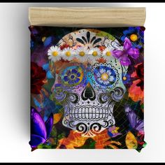 a colorful sugar skull with flowers on it's head is featured in this image