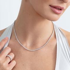 Callie Embrace modern elegance with our Lab Grown Diamond Tennis Necklace. This stunning piece features a continuous line of sparkling lab-grown diamonds, each meticulously set in a sleek and timeless design. Perfect for any occasion, this necklace offers the brilliance of diamonds with an eco-friendly touch. Whether you're dressing up for a special event or adding a touch of luxury to your everyday look, this tennis necklace is a versatile and sophisticated addition to your jewelry collection. Fine Jewelry Tennis Necklace With Brilliant Cut Cubic Zirconia, Fine Jewelry Cubic Zirconia Tennis Necklace With Brilliant Cut, Fine Jewelry Tennis Necklace With Diamond Cut Cubic Zirconia, Vvs Clarity Tennis Necklace For Wedding, Timeless Tennis Necklace With Brilliant Cut Cubic Zirconia, Wedding Fine Jewelry Tennis Necklace In Moissanite, Moissanite Tennis Necklace For Wedding, Wedding Moissanite Tennis Necklace, Timeless Diamond Tennis Necklace For Weddings