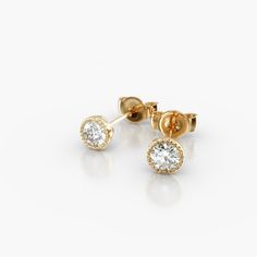 14K Yellow Gold Milgrain Bezel Diamond Stud Earrings (0.25 CTW - H-I / SI1-SI2). This design is the perfect mix of modern and vintage design, crafted to accent the beauty of the round brilliant diamonds with a milgrain bezel and rolled wire basket. This earring will fit slightly off the ear and features friction backs. Timeless Yellow Gold Bezel Set Earrings, Timeless Yellow Gold Earrings With Bezel Setting, Luxury Yellow Gold Earrings With Bezel Setting, Luxury Diamond Earrings With Bezel Setting, Timeless Diamond Earrings With Bezel Setting As Gift, Luxury Round Bezel Set Earrings, Elegant Round Cut Bezel Set Earrings, Luxury Formal Earrings With Bezel Setting, 14k Gold Bezel Set Diamond White Earrings