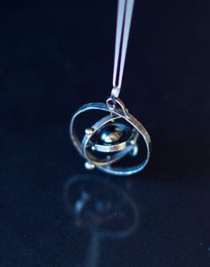 This kinetic solar system is hand made in sterling silver  Spinning Solar System… Astronomy Necklace, Solar System Necklace, Outer Planets, Wire Jewelry Patterns, Space Jewelry, Heart Pendant Gold, Space Planets, Fantasy Jewelry, Solar System