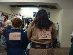 two people in costumes with signs on their backs