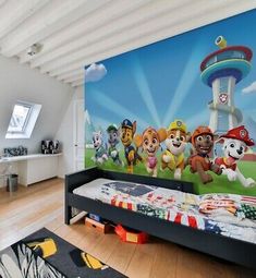 this is a bedroom with paw patrol murals on the wall and bed in the foreground