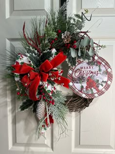 a christmas wreath hanging on the front door