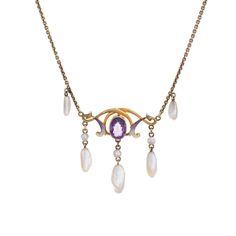 Stylish and finely detailed Art Nouveau drop necklace (circa 1900s to 1910s) crafted in 14 karat yellow gold.   One estimated .75 carat amethyst, 6mm x 3.5mm to 9mm x 3mm sawtooth pearls and enamel are set into the necklace. The amethyst is in very good condition and free of cracks or crisps. Note: slight chip to enamel.    The beautifully made Art Nouveau necklace highlights the faceted centre set oval amethyst with accenting purple and white enamel. Natural pearls are set in a fringe style to Formal Purple 14k Gold Necklace, Art Nouveau 14k Gold Jewelry With Gemstones, Classic Amethyst Pendant Necklace, Antique Teardrop Yellow Gold Necklaces, Antique Yellow Gold Teardrop Necklaces, Antique Yellow Gold Teardrop Necklace, Art Nouveau Yellow Gold Gemstone Necklaces, Classic Hallmarked Amethyst Necklace, Art Nouveau Gemstone Necklaces For Formal Occasions