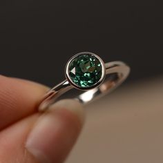 This is a gorgeous handmade creation. Its beauty is its simplicity & Elegance. The 7*7mm round cut lab green sapphire is crafted in solid sterling silver / 14k gold. It is available to customized, if you have any mind, just let me know, we will discuss with it. All item is sent in a beautiful gift box You can realize more lovely stuff clicking the link https://www.etsy.com/shop/knightjewelry?refshopsection_shophome_leftnav Please leave the correct address and you PHONE NUMBER for delivering Classic Green Tourmaline Jewelry, Green Sapphire Birthstone Rings, Silver Tourmaline Emerald Ring, Green Sapphire Round Ring, Elegant Green Birthstone Ring With Bezel Setting, Green Sapphire Ring For May Birthstone In Sterling Silver, Emerald Birthstone Ring With Bezel Setting, Green Sapphire Ring Sterling Silver, May Birthstone, Green Sapphire Sterling Silver Ring For May Birthstone