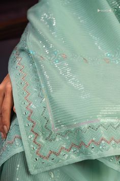 Enhance your ethnic wardrobe with this stunning sea green georgette saree adorned with exquisite sequin work, thread work, and zari work. Perfect for weddings, festivals, parties, and other special occasions, this saree is sure to make you stand out in the crowd.
The vibrant sea green color is eye-catching and flattering on all skin tones, making it a versatile and timeless addition to your collection.
The 5.50-meter saree comes with unstitched blouse material, allowing you to customize the perf Festive Pista Green Anarkali Set With Sequins, Pista Green Pre-draped Saree With Mirror Work For Navratri, Pista Green Anarkali Set With Sequins, Pista Green Sequined Anarkali Set For Party, Green Pre-draped Saree For Diwali Celebration, Festive Pista Green Pre-draped Saree With Gota Work, Pista Green Georgette Pre-draped Saree With Dupatta, Pista Green Sequined Georgette Lehenga, Bollywood Style Pista Green Sharara With Sequins