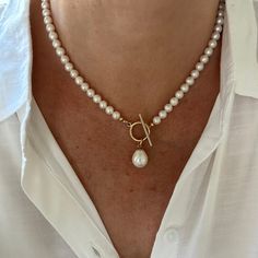 This classic white pearl necklace features a gorgeous 12x15mm smooth teardrop white freshwater pearl that drops elegantly from the gold filled toggle clasp. The necklace is made with 6mm high quality genuine AAA grade natural round freshwater pearls that have high luster and luminescence. These natural pearls have a superior polish, are perfectly calibrated, and are uniform in size.  - Not dyed, treated or color enhanced. 100% natural. - Photos taken outside in natural lighting and in a light bo Pear-shaped Pearl Drop Necklaces, Classic Pearl Charm Toggle Necklace, Classic Toggle Necklace With Pearl Charm For Gift, Classic Teardrop Baroque Pearl Necklace, Classic Pearl Drop Necklace With Pearl Charm, Classic Drop Pearl Necklace With Pearl Charm, White Toggle Necklace With Pearl Chain, Classic Pear-shaped Pearl Necklace With Charm, Classic Necklace With Teardrop Pearl Charm