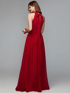 a woman in a long red dress is looking back