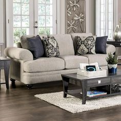 a living room filled with furniture and decor on top of a hard wood floored floor