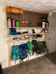 there are many backpacks hanging on the wall in this small room, and it's easy to use