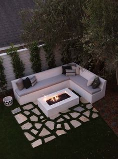 an outdoor fire pit in the middle of a yard