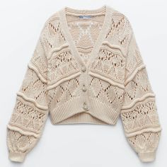 the sweater is knitted with an openwork pattern and has buttons at the front