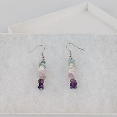 These genuine Capricorn dangle earrings from Wild Orchard Art have been hand-crafted and uniquely created from natural gemstones. This custom jewelry makes a great gift as well. About this Product: Type: dangle earringsGemstone: Amethyst, Purple Fluorite, Kunzite, Larimar, Moonstone Color: Purple-pink Vibes: Practical, organized, ambitious Other: Arrives gift boxed, cleansed and charged Gemstones: Amethyst (put mind and body at ease, step back from work) Fluorite (anti-stress, preventing burnout Peace Jewelry, Purple Fluorite, Pink Vibes, Amethyst Purple, Crystals And Gemstones, Natural Crystals, Handcrafted Jewelry, Good Vibes, Custom Jewelry