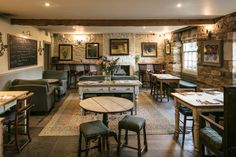 the interior of a restaurant with tables, chairs and couches in an old - fashioned setting