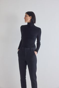 Made from premium ribbed fabric, this turtleneck sweater offers a luxurious feel against the skin. The ribbed texture adds depth to its design while providing a flattering and form-fitting silhouette that accentuates your curves in all the right places Modern Ribbed Sweater For Workwear, Modern Ribbed Sweater For Work, Black Turtleneck With Ribbed Cuffs For Work, Elegant Black Turtleneck With Ribbed Cuffs, Mock Neck Top For Work, Fitted Ribbed Modern Sweater, Chic Turtleneck With Funnel Neck In Fine Knit, Fitted Elastane Turtleneck For Fall, Classic Ribbed Turtleneck For Workwear