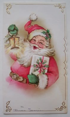 an old fashioned christmas card with a santa clause holding a gift bag and looking at the camera